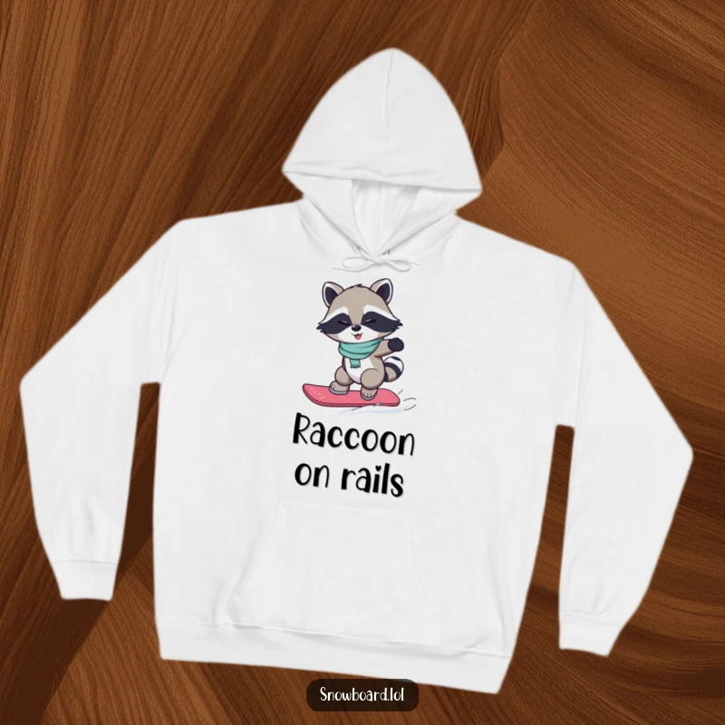 Funny hoodie depicting a winking raccoon executing a small jump on a snowboard, radiating playful confidence.